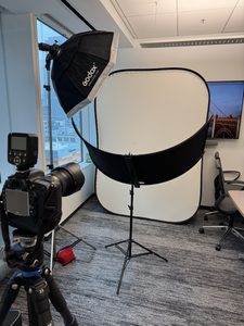 Image of a portable lighting setup for headshots in a conference room in an office building.