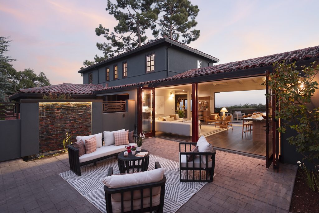 A large home with an open courtyard at twilight.